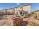 Backyard features a covered patio, a partial patio, and a block wall creating an outdoor living area at 24207 W Desert Bloom St, Buckeye, AZ 85326