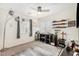 Bedroom featuring a ceiling fan, shelves for car models, and a gray rug, creating a cozy atmosphere at 24207 W Desert Bloom St, Buckeye, AZ 85326