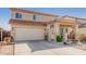 Charming two-story home featuring a tile roof, covered porch and attached two-car garage at 24207 W Desert Bloom St, Buckeye, AZ 85326