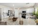 Modern kitchen with stainless steel appliances, granite countertops, and ample cabinet space at 24207 W Desert Bloom St, Buckeye, AZ 85326