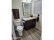 Well-lit bathroom featuring a new toilet, granite vanity, and wood-style flooring at 2710 S Noche De Paz --, Mesa, AZ 85202