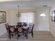 Charming dining room featuring a chandelier, a dining table with six chairs, and a window at 2710 S Noche De Paz --, Mesa, AZ 85202