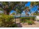 Serene backyard view with mature trees and gate leading to a tranquil lake setting at 2714 W Desert Cove Ave, Phoenix, AZ 85029