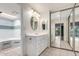 Bright bathroom boasts an updated vanity, mirrored closet, and adjacent shower and tub at 2714 W Desert Cove Ave, Phoenix, AZ 85029