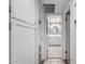 Bright hallway view reveals a fully equipped, well-lit bathroom with a linen closet at 2714 W Desert Cove Ave, Phoenix, AZ 85029