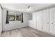 Cozy bedroom boasts light wood flooring, built-in closets, and a large window for ample natural light at 2714 W Desert Cove Ave, Phoenix, AZ 85029