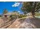 Charming home exterior with lush landscaping, a nearby sidewalk, and community lake views at 2714 W Desert Cove Ave, Phoenix, AZ 85029