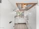 Bright kitchen with white appliances, countertops, and cabinets with a modern ceiling light fixture at 2714 W Desert Cove Ave, Phoenix, AZ 85029