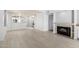 Spacious living room featuring light wood flooring, a fireplace, and an open floor plan with plenty of natural light at 2714 W Desert Cove Ave, Phoenix, AZ 85029
