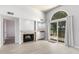 Cozy living room with a stone fireplace, light wood flooring, and a sliding glass door with views of the lake at 2714 W Desert Cove Ave, Phoenix, AZ 85029