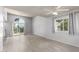 Bright living room featuring light wood flooring, a neutral color palette, and access to the patio at 2714 W Desert Cove Ave, Phoenix, AZ 85029