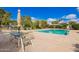 Community pool with tables and chairs provides a perfect spot for outdoor relaxation and socializing at 2714 W Desert Cove Ave, Phoenix, AZ 85029