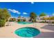 Community pool and spa surrounded by lounge chairs offer a relaxing outdoor experience under the clear blue sky at 2714 W Desert Cove Ave, Phoenix, AZ 85029