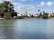 Expansive lake view showcasing waterfront homes and lush greenery under a partly cloudy sky at 2714 W Desert Cove Ave, Phoenix, AZ 85029