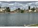 Scenic lake view with palm trees and residential buildings under a cloudy sky at 2714 W Desert Cove Ave, Phoenix, AZ 85029