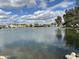 Serene lake view with residential buildings under a partly cloudy sky, framed by lush trees at 2714 W Desert Cove Ave, Phoenix, AZ 85029