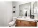 Cozy half-bathroom featuring a pedestal sink, nice mirror, and motivational artwork at 284 N 199Th Dr, Buckeye, AZ 85326