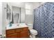 Bathroom with a mirror, a sink, and a blue shower curtain at 284 N 199Th Dr, Buckeye, AZ 85326