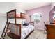 Bedroom with a bunk bed, window, and a view of the community outside at 284 N 199Th Dr, Buckeye, AZ 85326