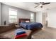 Bedroom with a ceiling fan, carpet, and views of the surrounding mountains at 284 N 199Th Dr, Buckeye, AZ 85326