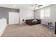 Playful bedroom with a gray accent wall, plush carpet, a play table, and sofa at 284 N 199Th Dr, Buckeye, AZ 85326