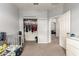 Bedroom with crib and an open door that leads to other rooms at 284 N 199Th Dr, Buckeye, AZ 85326