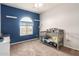 Bedroom with a crib, window, and decorated in blue at 284 N 199Th Dr, Buckeye, AZ 85326