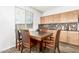 Cozy dining area featuring tile backsplash and wood floors at 284 N 199Th Dr, Buckeye, AZ 85326