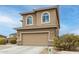 Two-story home with two-car garage, desert landscaping, and unique arched windows at 284 N 199Th Dr, Buckeye, AZ 85326
