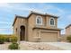 Inviting two-story home featuring an arched entryway and neutral desert tones at 284 N 199Th Dr, Buckeye, AZ 85326
