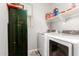 Laundry room with modern appliances, including a washer, dryer, storage and natural light from a window at 284 N 199Th Dr, Buckeye, AZ 85326