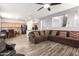 Spacious living room with view into the kitchen, featuring stylish wood floors and a comfortable sectional sofa at 284 N 199Th Dr, Buckeye, AZ 85326