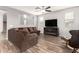 Comfortable living room with a ceiling fan, nice floors, and a cozy fireplace with a TV at 284 N 199Th Dr, Buckeye, AZ 85326