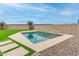 Sparkling pool with a decorative wall fountain, framed by lush turf and desert landscaping, creates a private oasis at 284 N 199Th Dr, Buckeye, AZ 85326