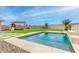 Inviting pool amidst a backyard with artificial turf and a playground, perfect for Gathering enjoyment and outdoor activities at 284 N 199Th Dr, Buckeye, AZ 85326