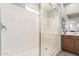 Clean walk-in shower with a glass enclosure, built-in seat, and modern fixtures at 284 N 199Th Dr, Buckeye, AZ 85326