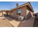 Side view of backyard with AC unit, brick paver pathway and covered patio at 2842 S Royal Wood --, Mesa, AZ 85212