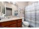 Bathroom with a shower and tub, wooden vanity, and large mirror at 2842 S Royal Wood --, Mesa, AZ 85212