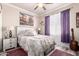 Bedroom with a ceiling fan, carpet, a window with purple curtains, and a painting above the bed at 2842 S Royal Wood --, Mesa, AZ 85212