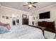 Bedroom with a television, carpet, and views of a walk-in closet and the kitchen at 2842 S Royal Wood --, Mesa, AZ 85212