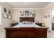 Bright bedroom showcasing a dark wood bed frame, neutral walls and carpet, and decorative wall art at 2842 S Royal Wood --, Mesa, AZ 85212