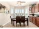 Cozy breakfast nook featuring plantation shutters, tile flooring, and a view of the lush backyard at 2842 S Royal Wood --, Mesa, AZ 85212