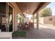 Covered patio with brick pavers, ceiling fan, exterior lights, and patio furniture at 2842 S Royal Wood --, Mesa, AZ 85212