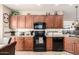 Well-equipped kitchen features stainless appliances, granite counters, and ample wood cabinetry at 2842 S Royal Wood --, Mesa, AZ 85212