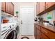 Updated laundry room with washer, dryer, butcher block countertops and brown wooden cabinets at 2842 S Royal Wood --, Mesa, AZ 85212