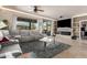 Open living room featuring a modern fireplace, neutral tones, plush seating, and bright, natural light at 2842 S Royal Wood --, Mesa, AZ 85212
