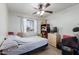 Bedroom with white walls, a bed with blue covers, ceiling fan and boxes stacked at 306 N Winthrop Cir, Mesa, AZ 85213
