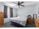 Bright bedroom with a ceiling fan, large window, and ample space for storage at 306 N Winthrop Cir, Mesa, AZ 85213
