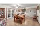 Cozy dining area featuring a classic table set, adjacent to the kitchen with ample light at 306 N Winthrop Cir, Mesa, AZ 85213