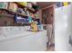 Laundry room featuring washer, dryer, shelving, storage containers, and utility appliances at 306 N Winthrop Cir, Mesa, AZ 85213
